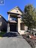 View of front facade with stone siding, a balcony, driveway, and a garage - 1165 West 5Th Street, Hamilton, ON  - Outdoor 