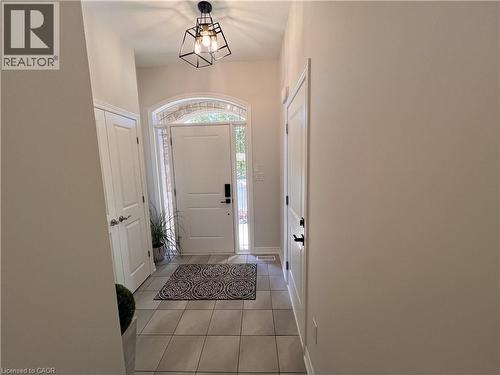 Entryway with light tile patterned flooring and baseboards - 1165 West 5Th Street, Hamilton, ON - Indoor Photo Showing Other Room