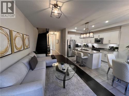 Living room with light tile patterned floors and recessed lighting - 1165 West 5Th Street, Hamilton, ON - Indoor