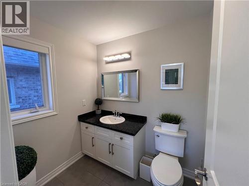 Half bath with vanity and dark tile patterned floors - 1165 West 5Th Street, Hamilton, ON - Indoor Photo Showing Bathroom