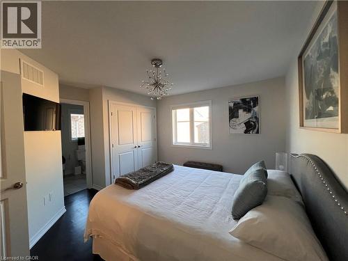 Bedroom featuring a chandelier, a closet, and dark wood-style flooring - 1165 West 5Th Street, Hamilton, ON - Indoor Photo Showing Bedroom
