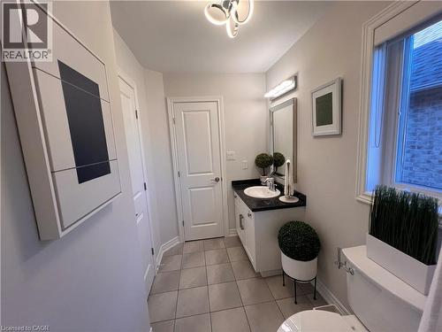 Half bath with vanity and light tile patterned flooring - 1165 West 5Th Street, Hamilton, ON - Indoor Photo Showing Bathroom