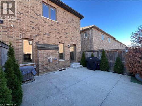 Back of house featuring brick siding and a patio area - 1165 West 5Th Street, Hamilton, ON - Outdoor With Exterior