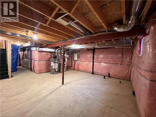Unfinished basement with gas water heater, heating unit, and electric panel - 1165 West 5Th Street, Hamilton, ON - Indoor Photo Showing Basement