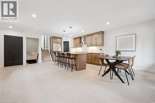 Kitchen with a kitchen bar, a center island, light countertops, decorative backsplash, and decorative light fixtures - 459 Drummerhill Crescent, Waterloo, ON - Indoor