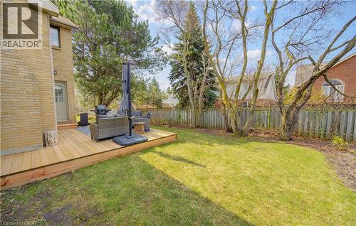 Fenced backyard with an outdoor living space and a deck - 306 Roxton Drive, Waterloo, ON - Outdoor