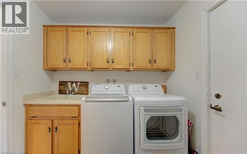 Laundry area featuring cabinet space and independent washer and dryer - 306 Roxton Drive, Waterloo, ON - Indoor Photo Showing Laundry Room