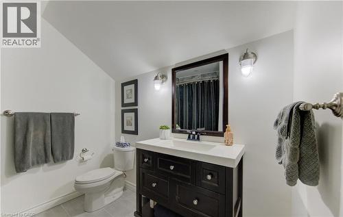 Full bathroom with vanity, light tile patterned flooring, a shower with curtain, and lofted ceiling - 306 Roxton Drive, Waterloo, ON - Indoor Photo Showing Bathroom