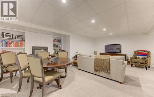 Dining space with a paneled ceiling, built in features, a fireplace, light carpet, and recessed lighting - 306 Roxton Drive, Waterloo, ON - Indoor