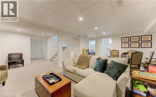 Living room with a paneled ceiling, recessed lighting, and light colored carpet - 306 Roxton Drive, Waterloo, ON - Indoor