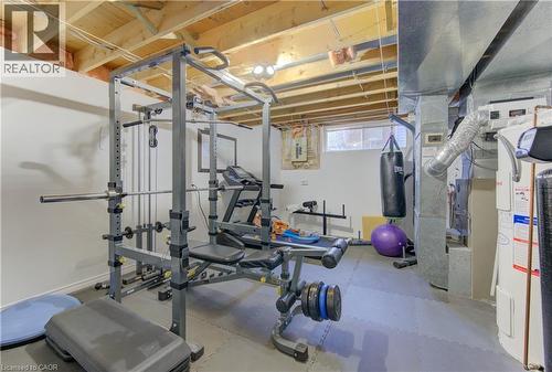 Exercise room featuring electric water heater and light rubber floors - 306 Roxton Drive, Waterloo, ON - Indoor Photo Showing Gym Room