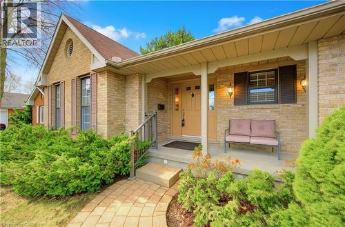 Property entrance featuring a porch and brick siding - 306 Roxton Drive, Waterloo, ON - Outdoor With Deck Patio Veranda