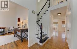 Stairway with hardwood / wood-style floors and a high ceiling - 