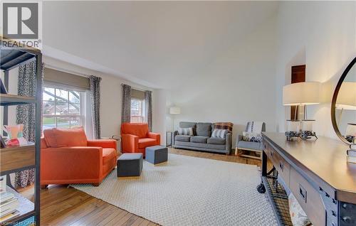 Living room with hardwood / wood-style flooring and lofted ceiling - 306 Roxton Drive, Waterloo, ON - Indoor