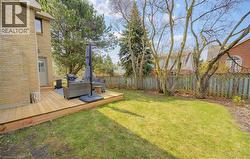 Fenced backyard with an outdoor living space and a deck - 