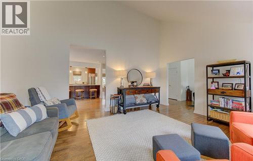 Living area with wood-type flooring and lofted ceiling - 306 Roxton Drive, Waterloo, ON - Indoor Photo Showing Living Room