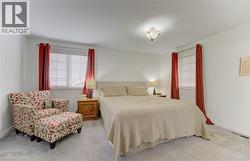 Bedroom with light carpet and multiple windows - 