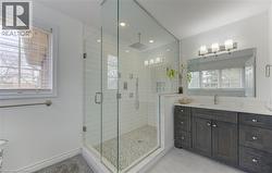 Full bathroom with vanity, a stall shower, light tile patterned floors, and recessed lighting - 