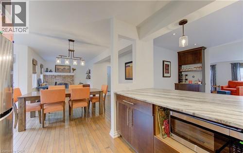 Kitchen featuring stainless steel appliances, open floor plan, and hanging light fixtures - 306 Roxton Drive, Waterloo, ON - Indoor