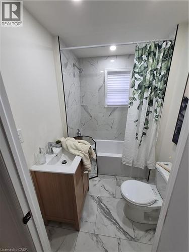Full bath with vanity, light marble finish floors, and shower / tub combo with curtain - 7 Stapleton Avenue, Hamilton, ON - Indoor Photo Showing Bathroom