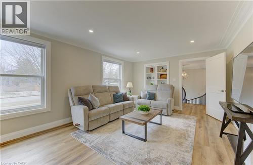 Living area featuring light wood-style floors, built in features, recessed lighting, and crown molding - 395 Warrington Drive, Waterloo, ON - Indoor Photo Showing Living Room