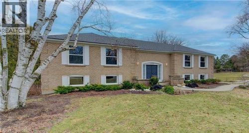 Raised ranch featuring brick siding and a front lawn - 395 Warrington Drive, Waterloo, ON - Outdoor