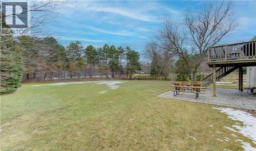 View of green lawn with a patio and a wooden deck - 395 Warrington Drive, Waterloo, ON - Outdoor