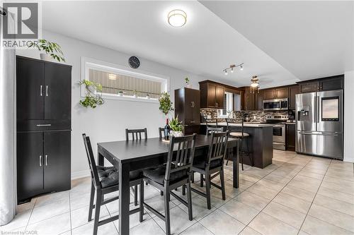 Dining area featuring light tile patterned flooring and rail lighting - 160 Wallace Avenue S, Welland, ON - Indoor