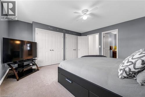 Bedroom with two closets, light colored carpet, a ceiling fan, and ensuite bath - 160 Wallace Avenue S, Welland, ON - Indoor Photo Showing Bedroom