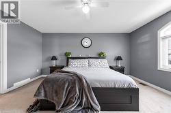 Bedroom with carpet flooring and a ceiling fan - 