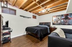 Bedroom with baseboards and wood finished floors - 