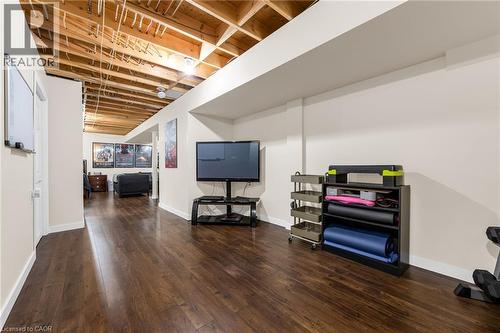 Finished basement with dark wood-type flooring and baseboards - 160 Wallace Avenue S, Welland, ON - Indoor
