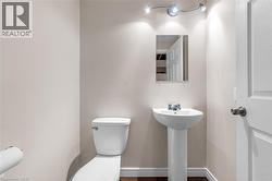 Bathroom featuring toilet and baseboards - 