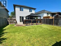 Rear view of property with a gazebo, a deck, and a fenced backyard - 