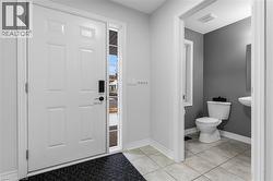 Entrance foyer featuring baseboards and light tile patterned flooring - 