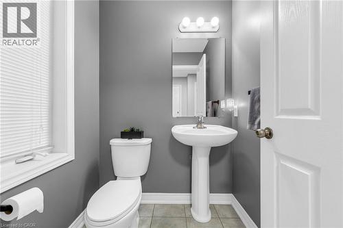 Bathroom featuring toilet and light tile patterned floors - 160 Wallace Avenue S, Welland, ON - Indoor Photo Showing Bathroom