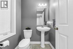 Bathroom featuring toilet and light tile patterned floors - 