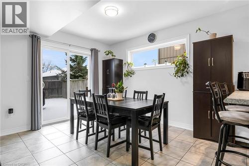 Dining space with healthy amount of natural light and light tile patterned floors - 160 Wallace Avenue S, Welland, ON - Indoor Photo Showing Dining Room