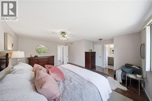 Bedroom featuring wood finished floors, a ceiling fan, and ensuite bath - 200 Morrison Drive, Caledonia, ON - Indoor Photo Showing Bedroom