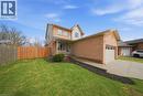 View of front facade featuring a garage, concrete driveway, brick siding, and board and batten siding - 200 Morrison Drive, Caledonia, ON  - Outdoor 