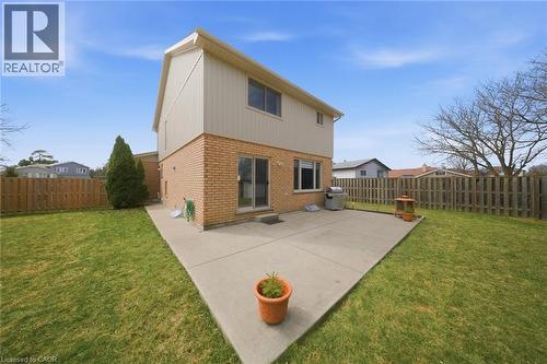 Rear view of property featuring brick siding, a patio, and a fenced backyard - 200 Morrison Drive, Caledonia, ON - Outdoor