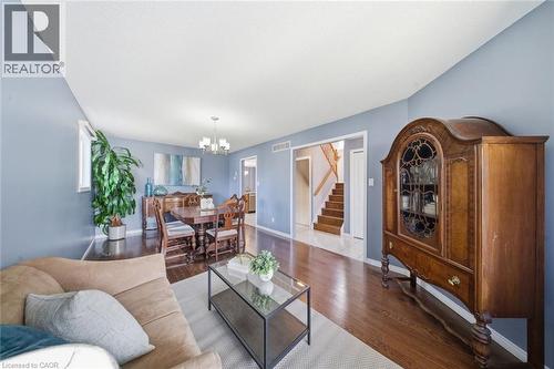 Living area with wood finished floors and a chandelier - 200 Morrison Drive, Caledonia, ON - Indoor Photo Showing Living Room