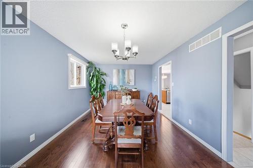 Dining space featuring hardwood / wood-style floors and a chandelier - 200 Morrison Drive, Caledonia, ON - Indoor Photo Showing Dining Room