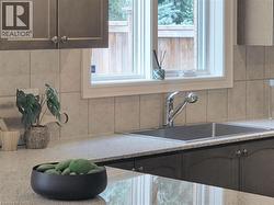 Kitchen view of decorative backsplash and light stone countertops - 