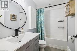 Full bath featuring vanity and shower / tub combo with curtain - 