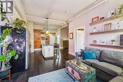 Living area with dark wood finished floors and baseboards - 