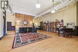 Living area featuring a high ceiling and light wood-style floors - 