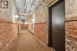 Hall with brick wall and carpet - 