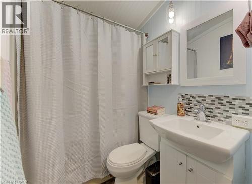 Full bath featuring vanity, curtained shower, and decorative backsplash - 580 Beaver Creek Road Unit# 11, Waterloo, ON - Indoor Photo Showing Bathroom
