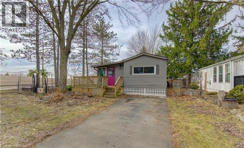 Manufactured / mobile home featuring a deck and asphalt driveway - 580 Beaver Creek Road Unit# 11, Waterloo, ON - Outdoor